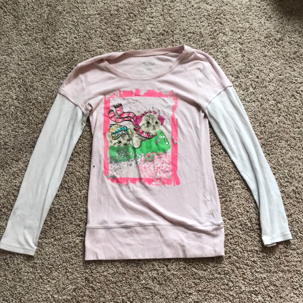 pink and white cat sledding shirt